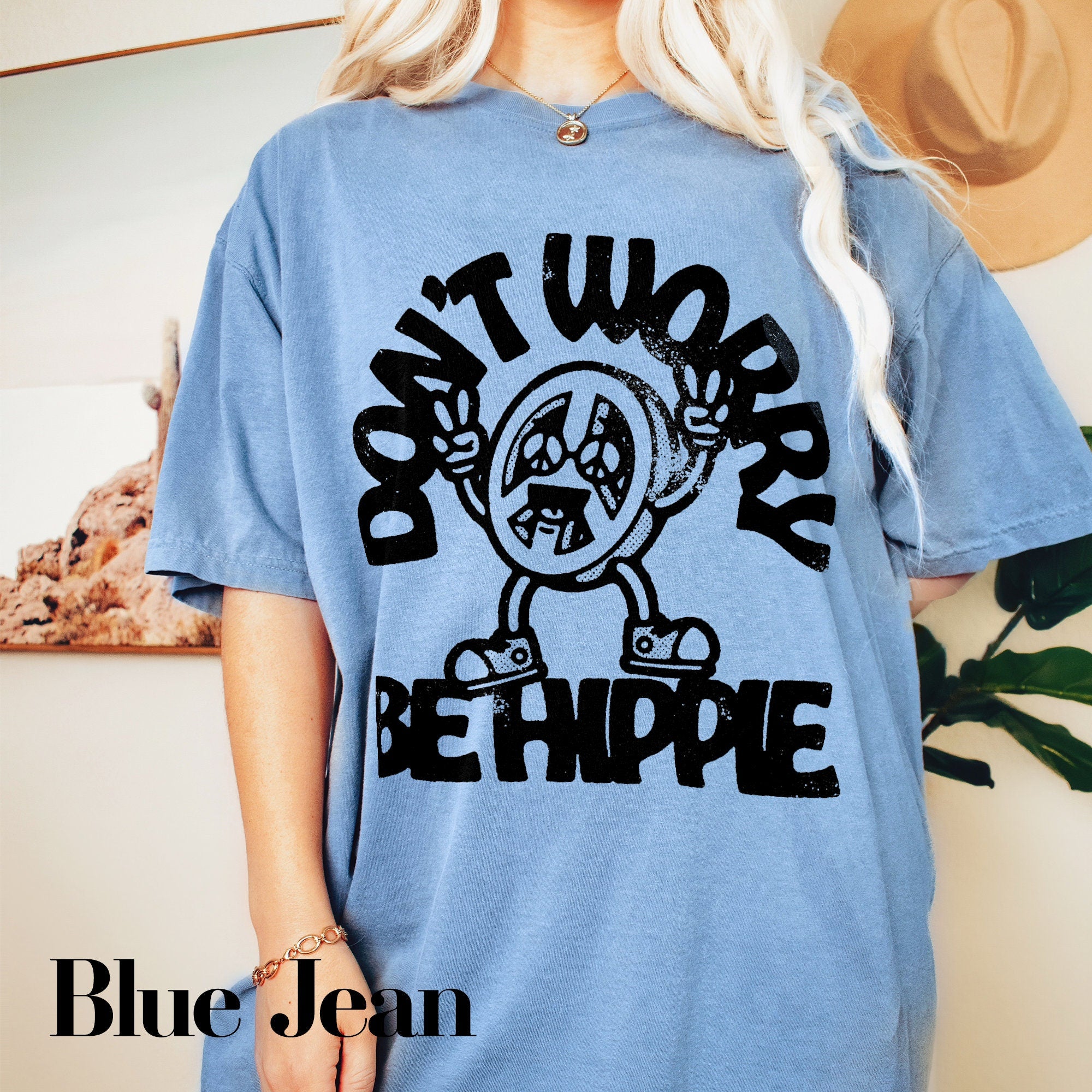 a woman wearing a blue t - shirt that says don&#39;t work, be
