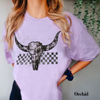 a woman wearing a purple shirt with a cow skull on it