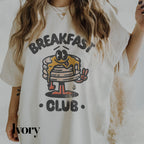 a woman wearing a t - shirt that says breakfast club
