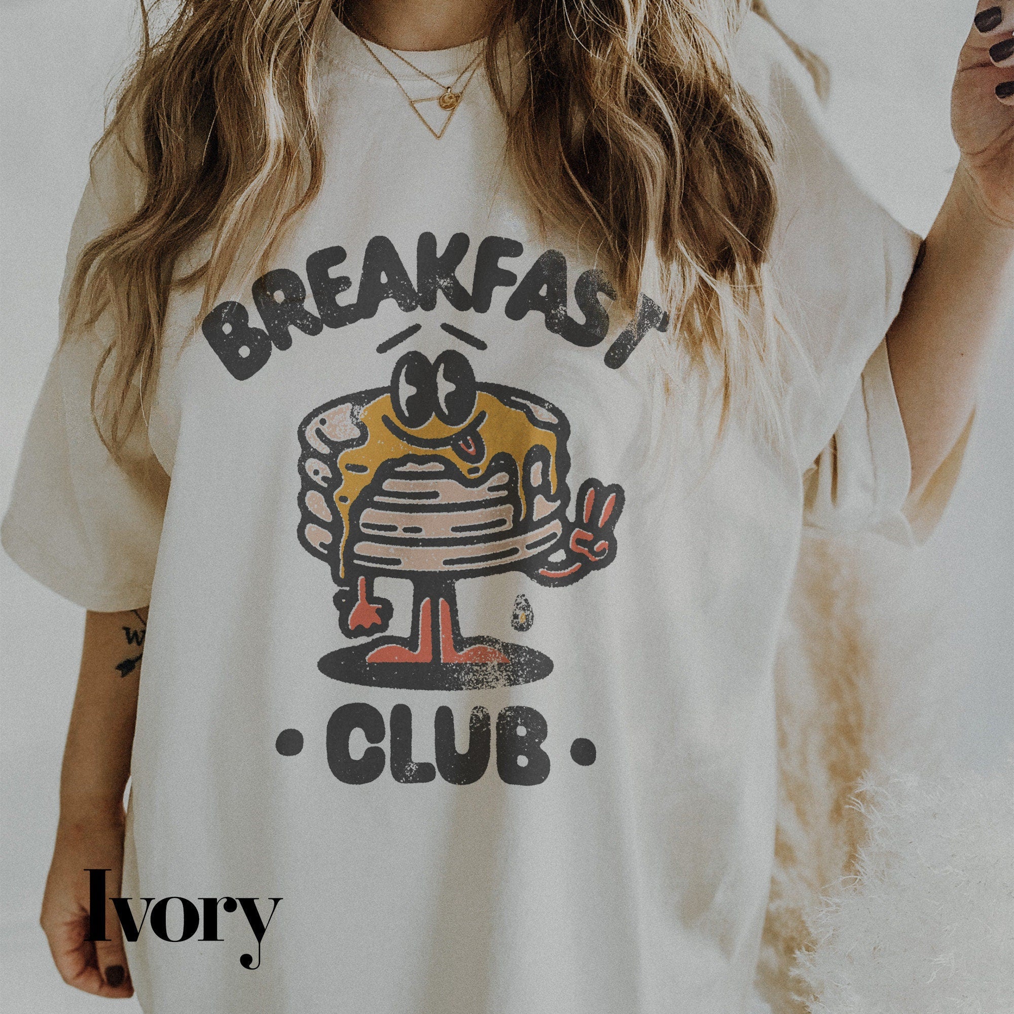 a woman wearing a t - shirt that says breakfast club