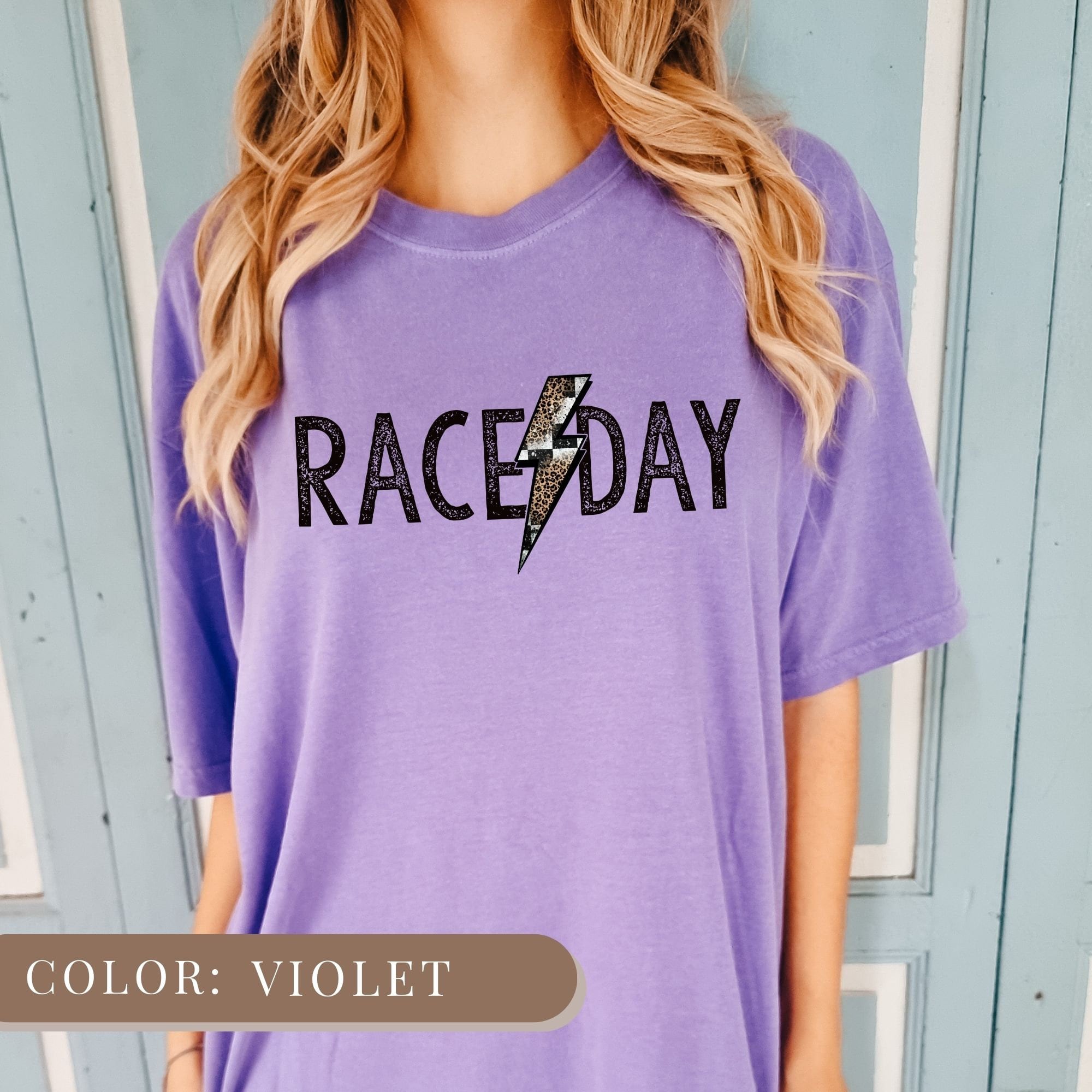a woman wearing a purple race day shirt