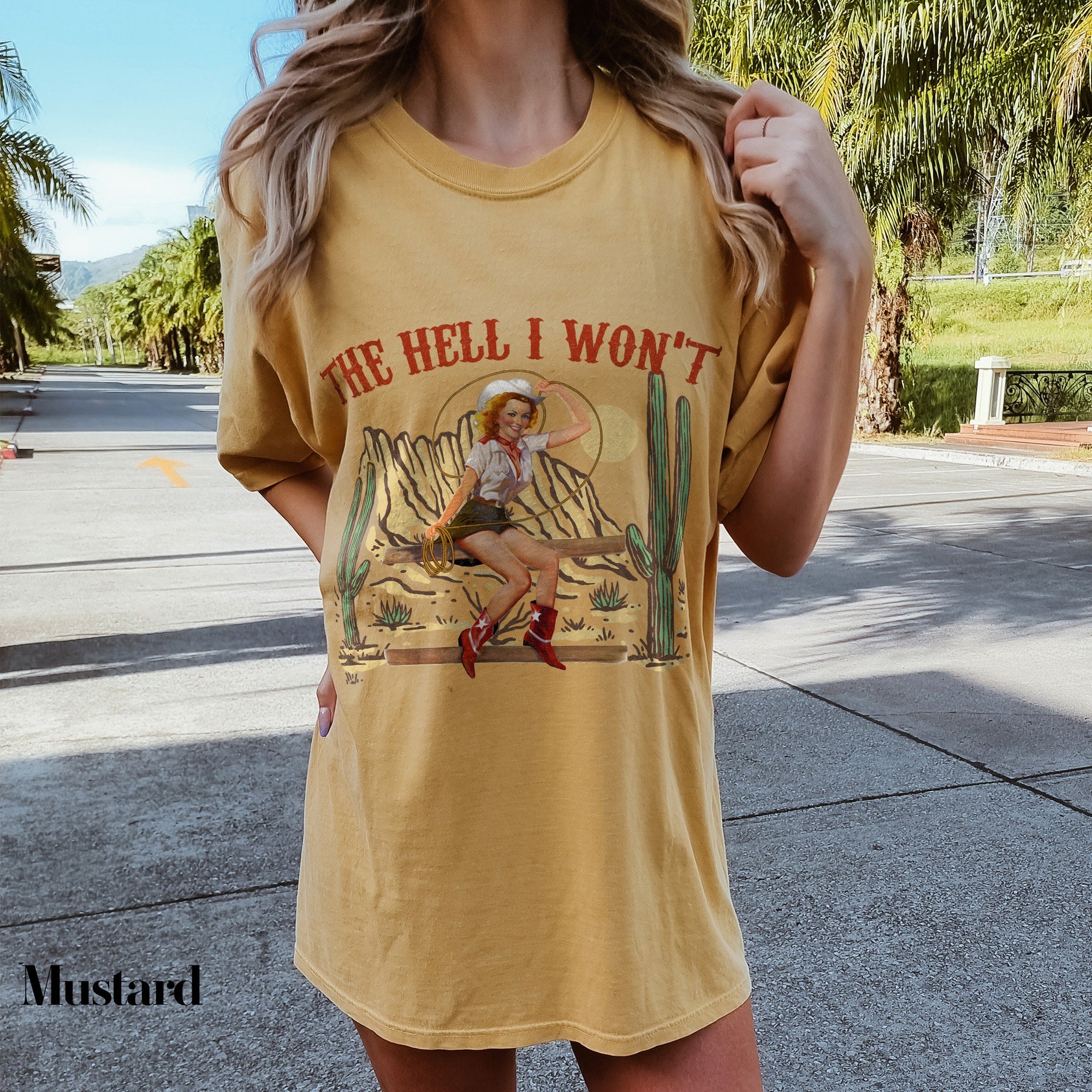 a woman wearing a yellow shirt with a picture of a woman on it