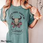 a woman wearing a t - shirt that says wild and free can&#39;t be
