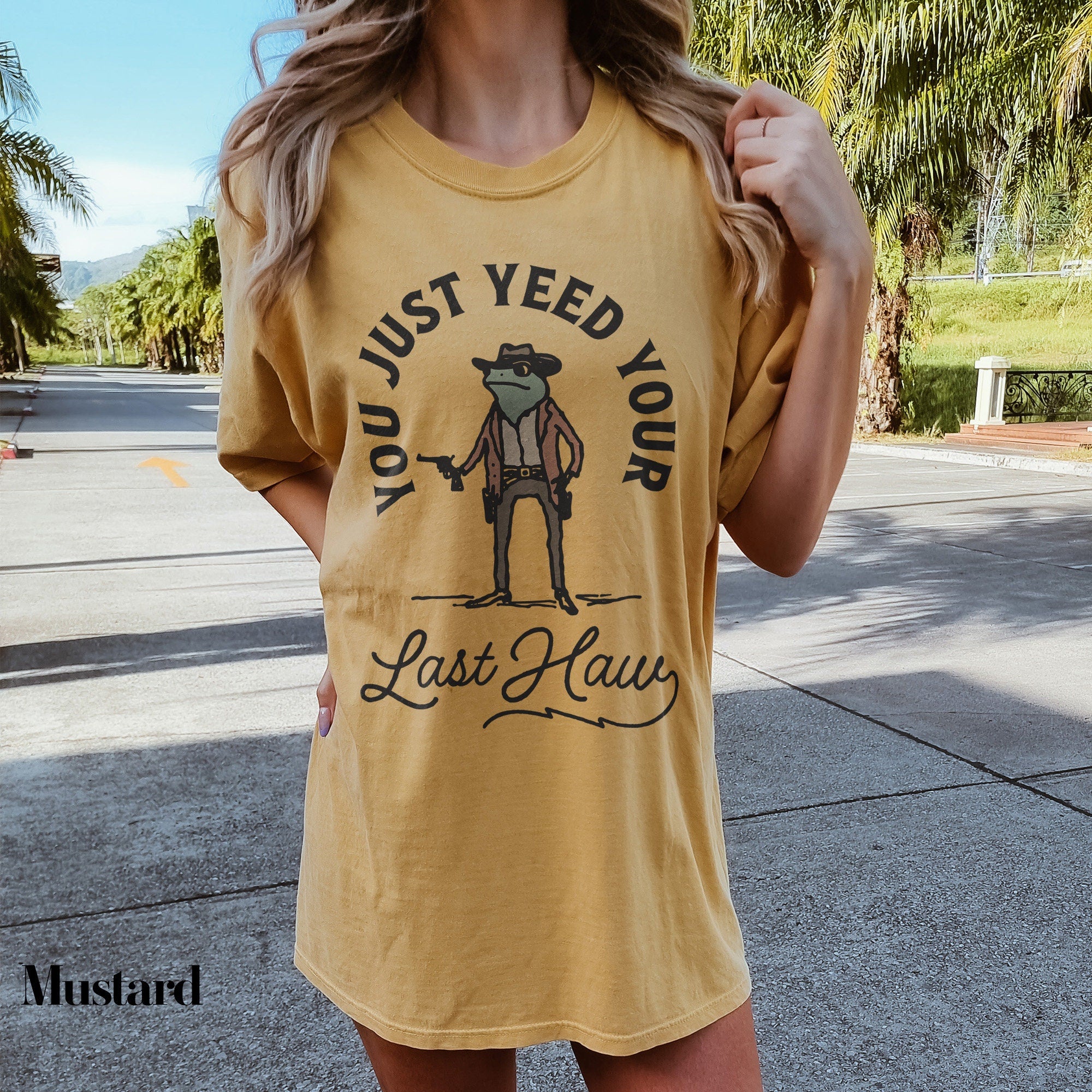 a woman wearing a yellow shirt that says just need your last name
