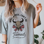 a woman holding a cigarette and wearing a t - shirt that says wild, free
