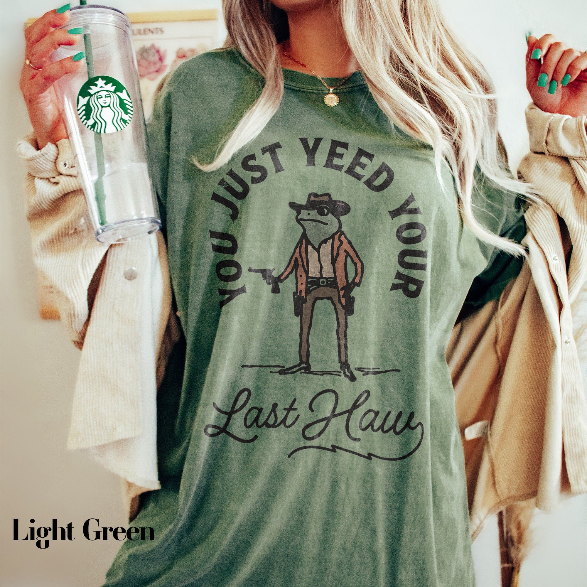 a woman holding a starbucks cup and a starbucks drink