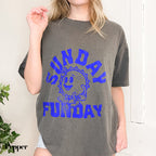 a woman wearing a gray shirt with blue writing on it