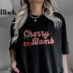 a woman wearing a black cherry bomb t - shirt