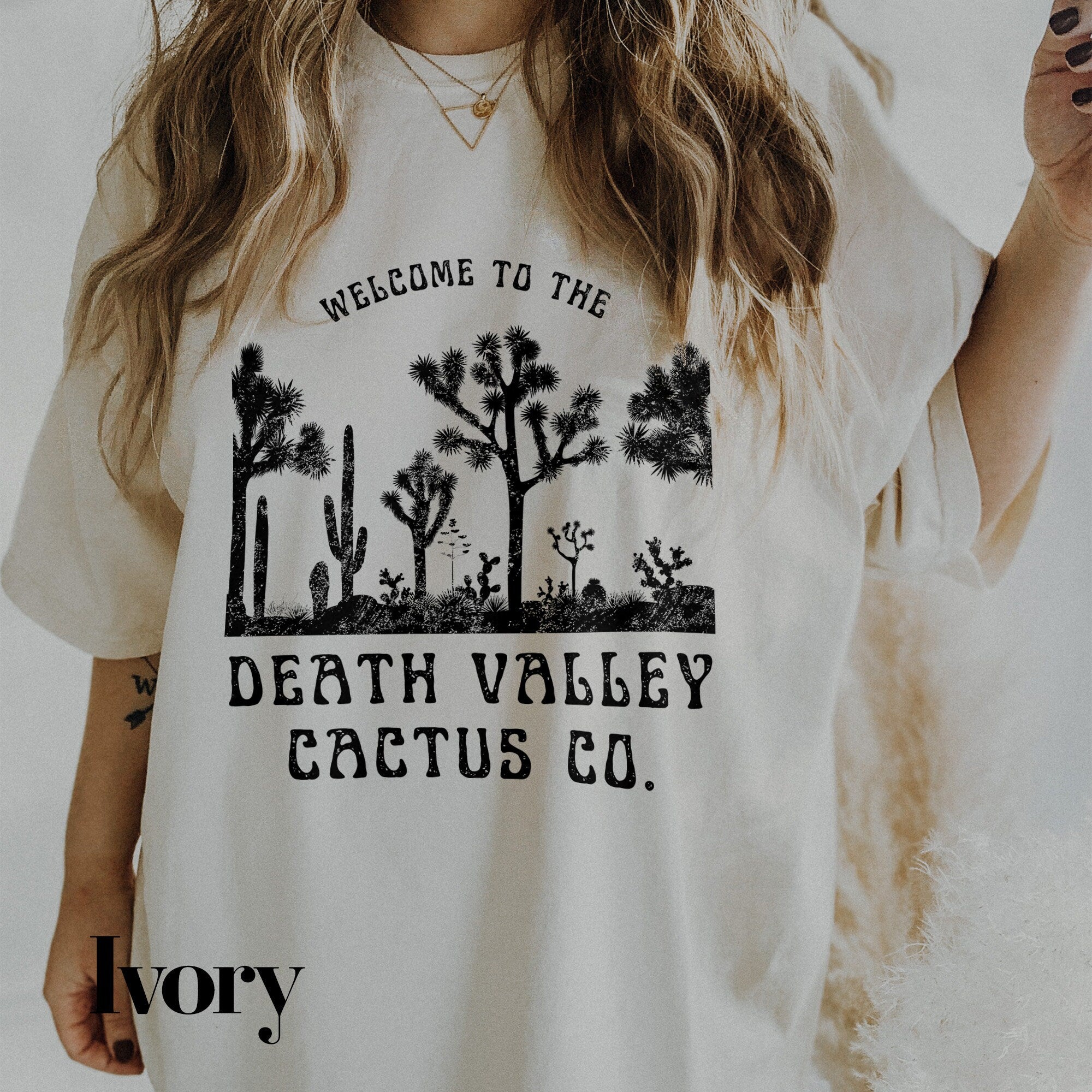 a woman wearing a t - shirt that says, welcome to the death valley cactus