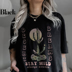 a woman wearing a black shirt with a cactus on it