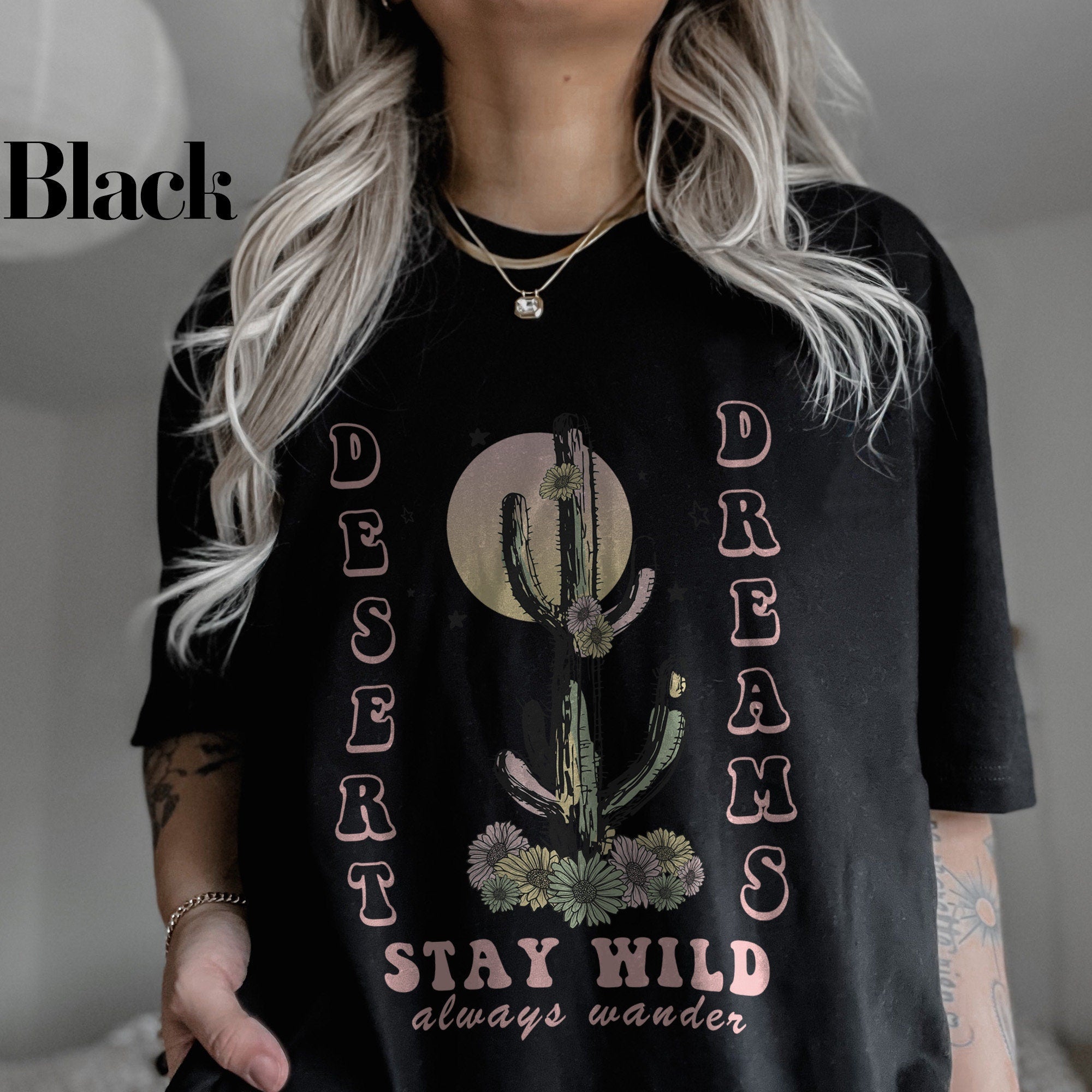 a woman wearing a black shirt with a cactus on it