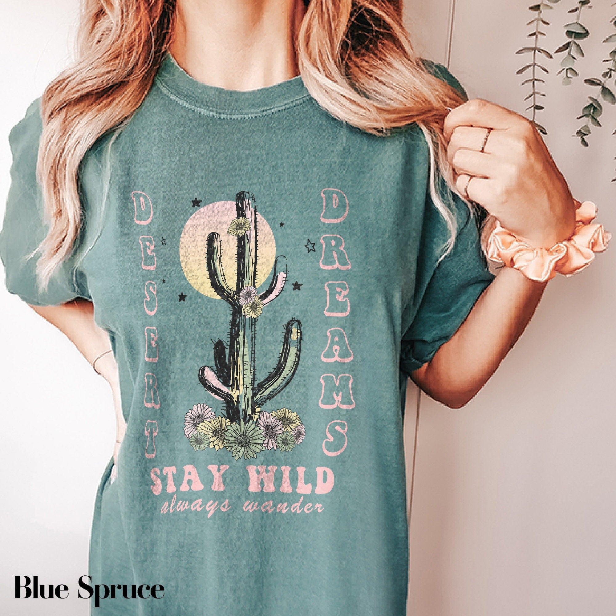 a woman wearing a green shirt with a cactus on it
