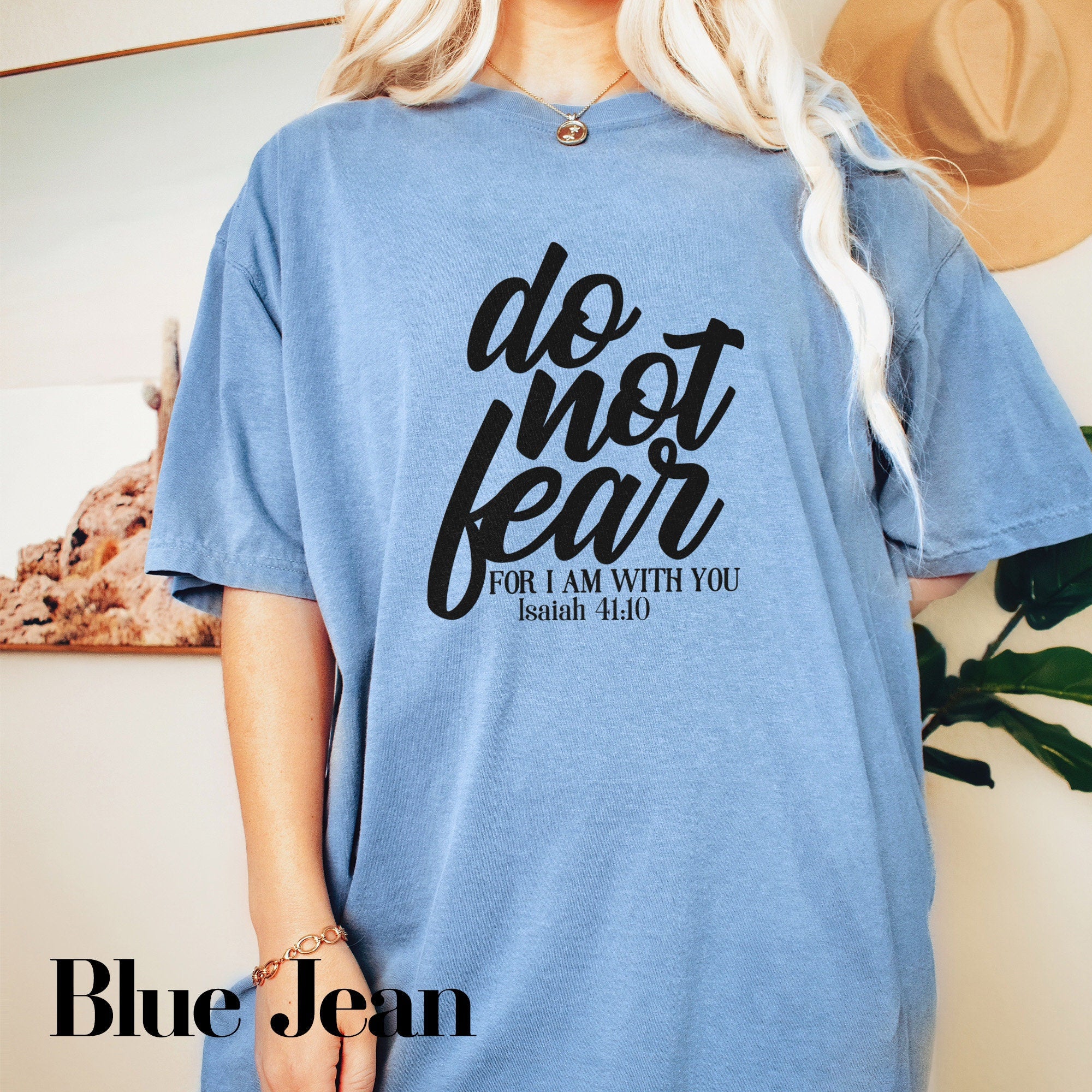 a blonde woman wearing a blue t - shirt that says do not fear for law