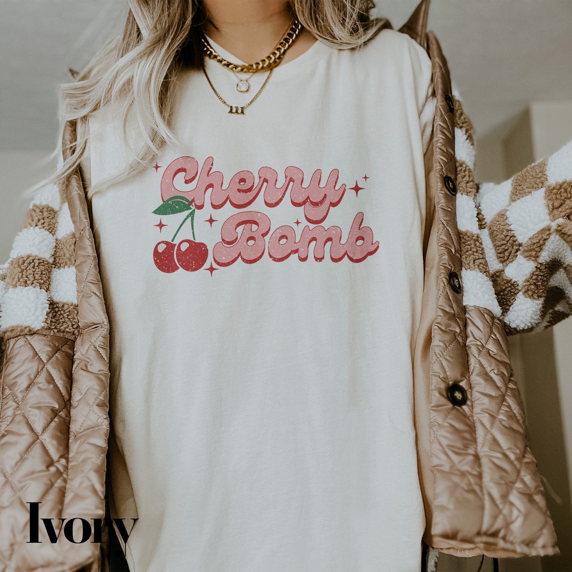 a woman wearing a cherry bomb t - shirt