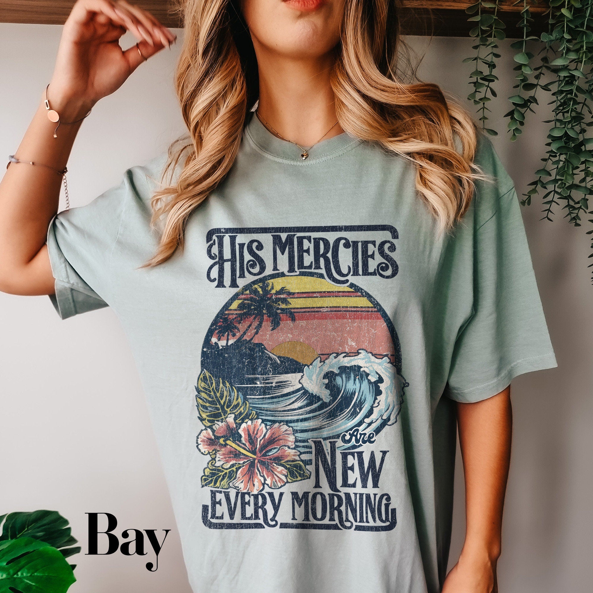 a woman wearing a t - shirt that says his mercies are new every morning