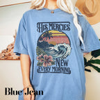 a woman wearing a blue shirt with a picture of a wave