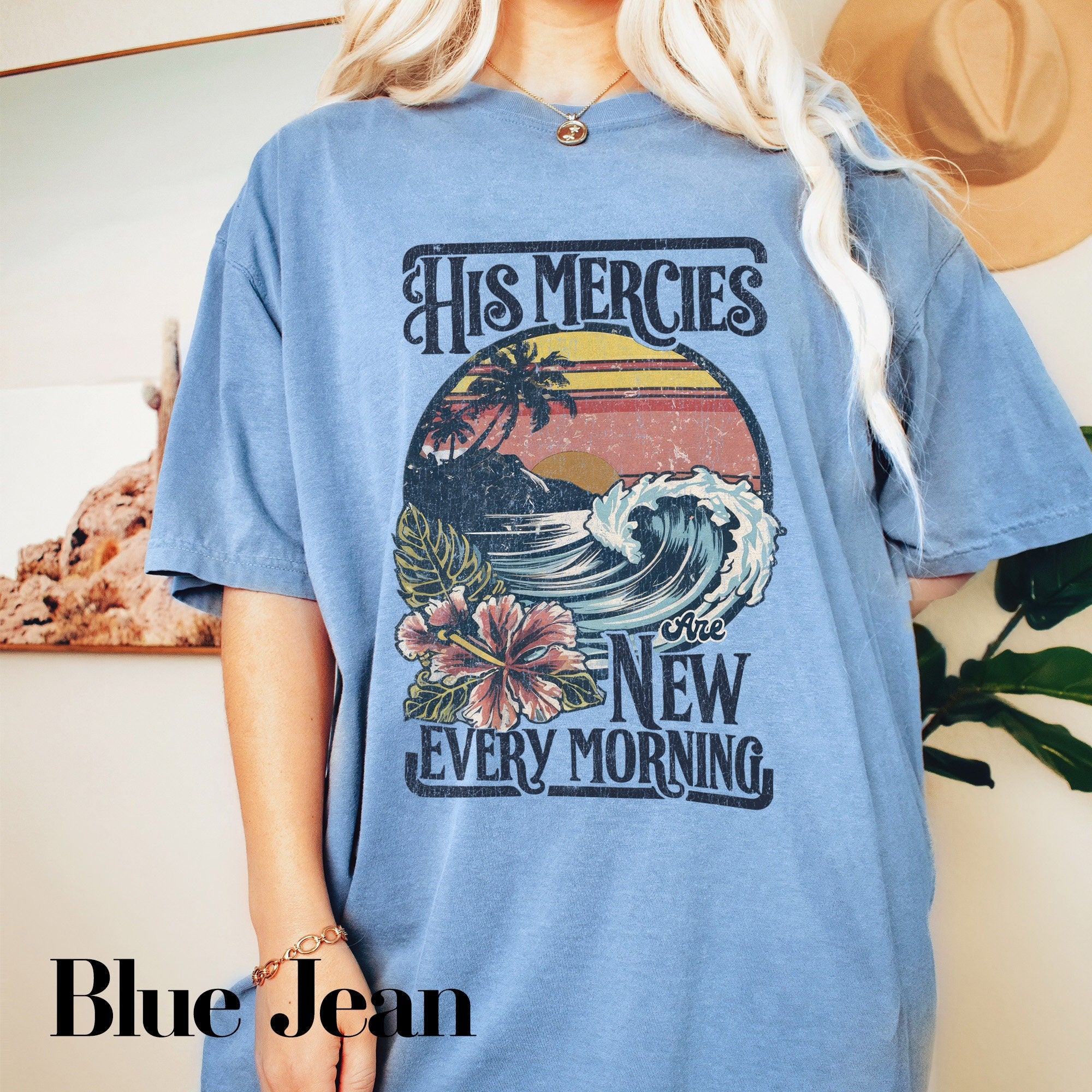 a woman wearing a blue shirt with a picture of a wave