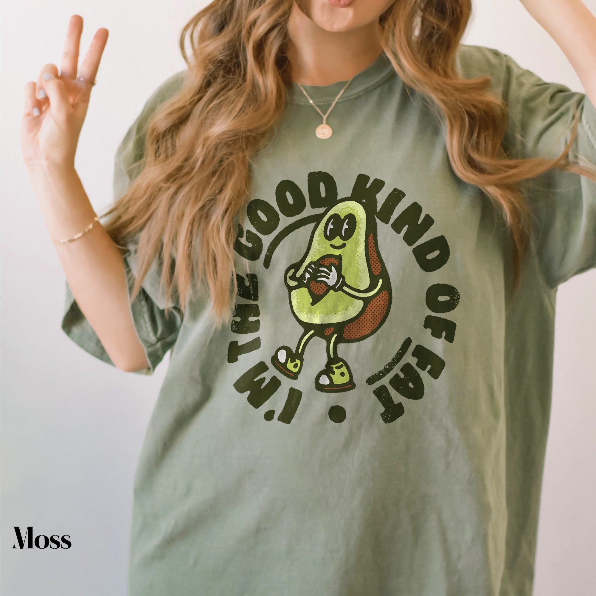 a woman with long hair wearing a green shirt