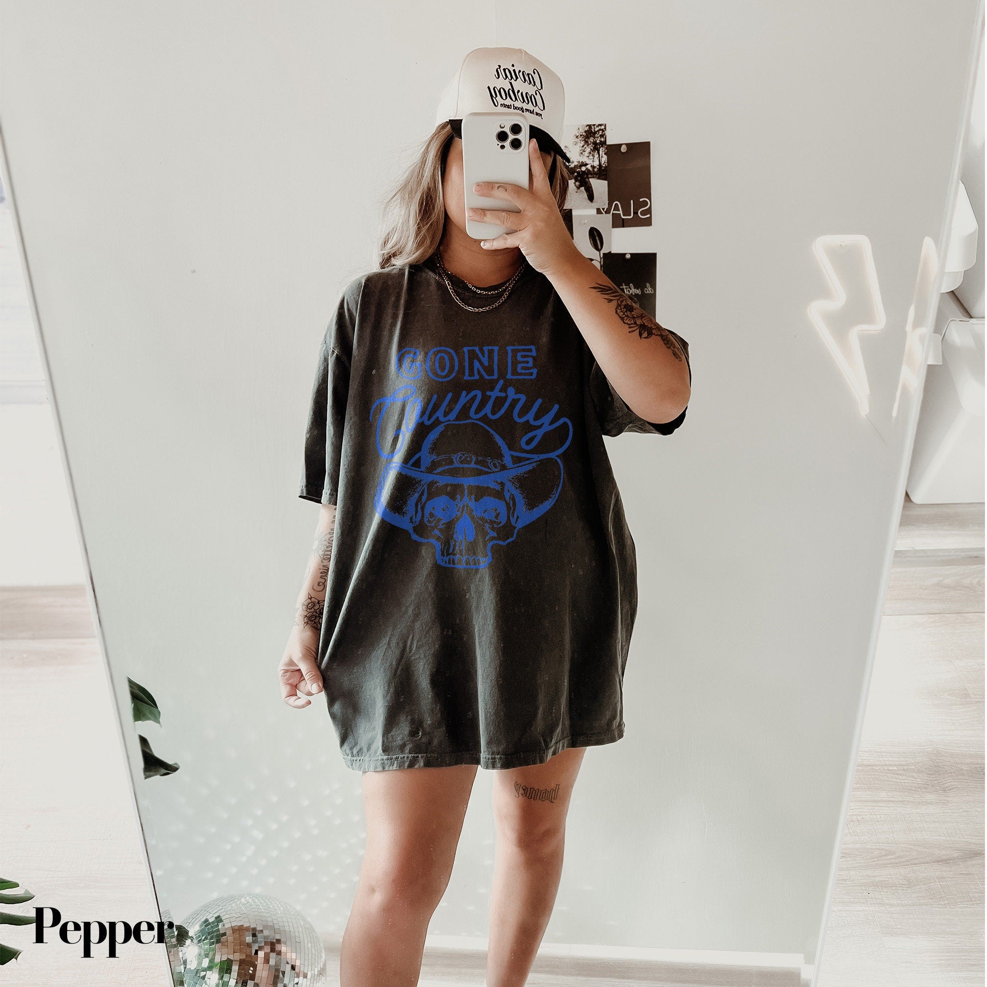 a woman taking a selfie in front of a mirror