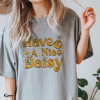 a woman holding a cigarette and wearing a t - shirt that says have a nice