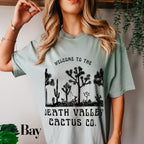 a woman wearing a t - shirt that says, welcome to the death valley cactus