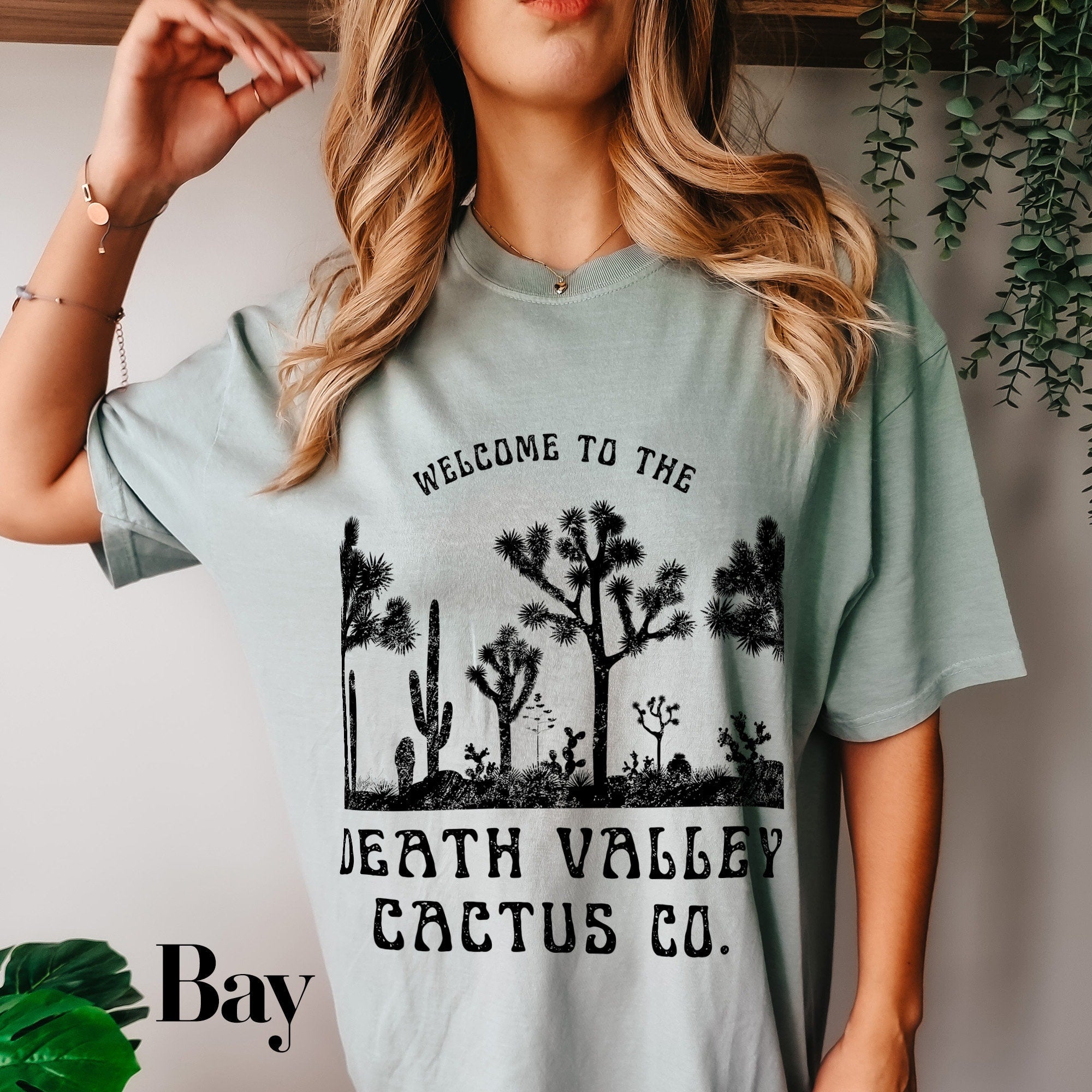 a woman wearing a t - shirt that says, welcome to the death valley cactus