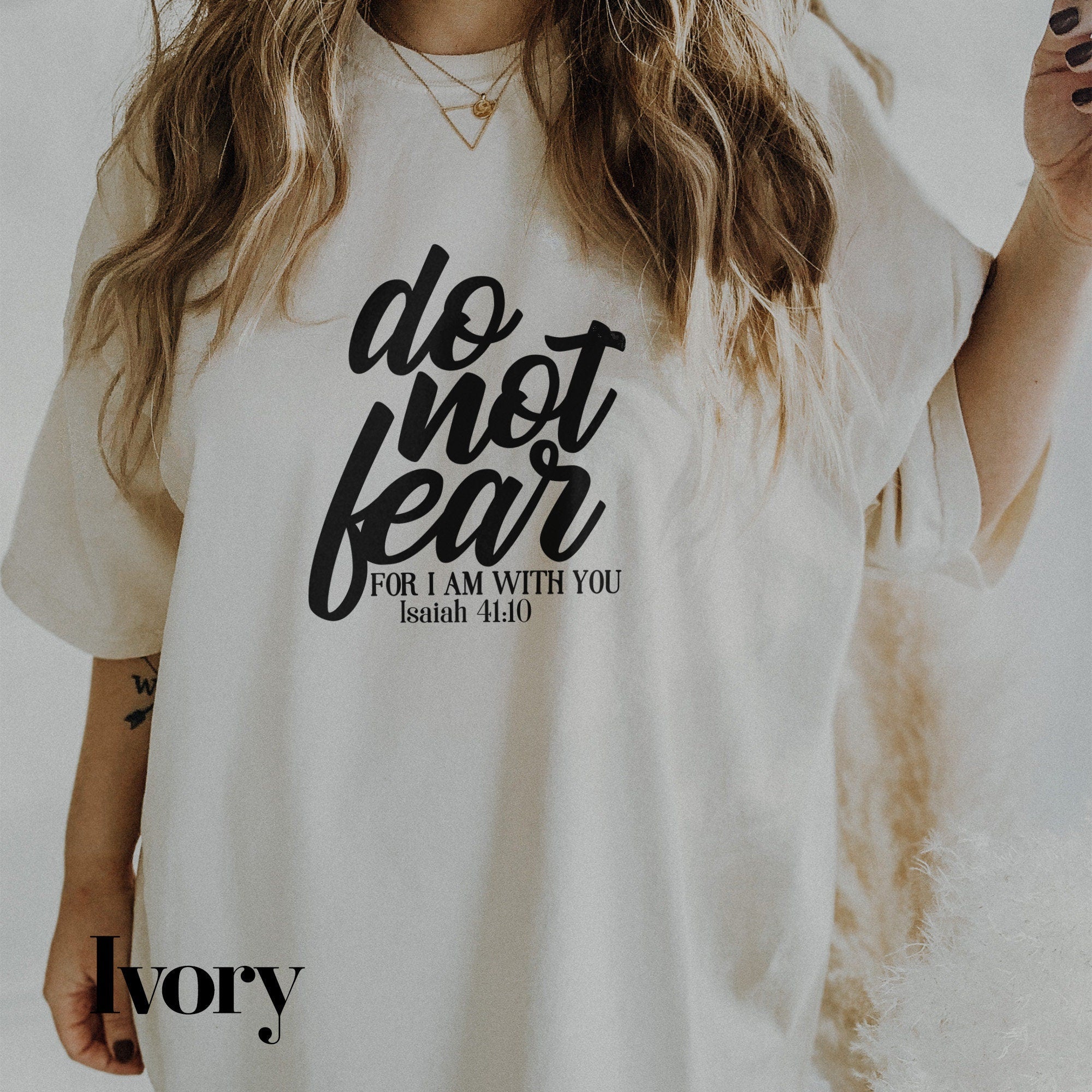 a woman wearing a white shirt that says do not fear