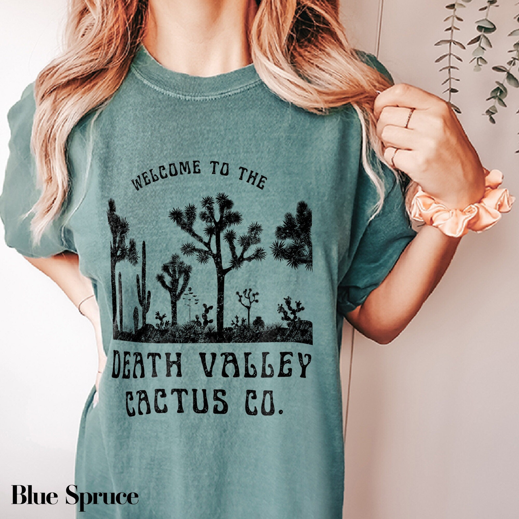 a woman wearing a t - shirt that says, welcome to the death valley cactus