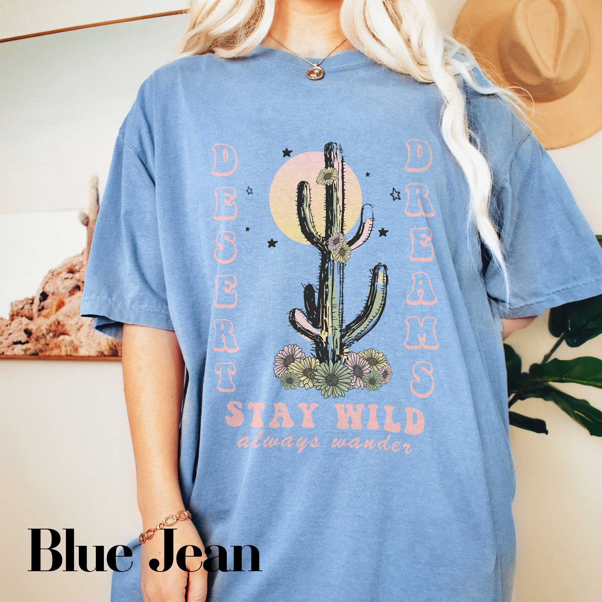 a woman wearing a blue shirt with a cactus on it