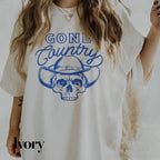 a woman wearing a white shirt with a skull on it