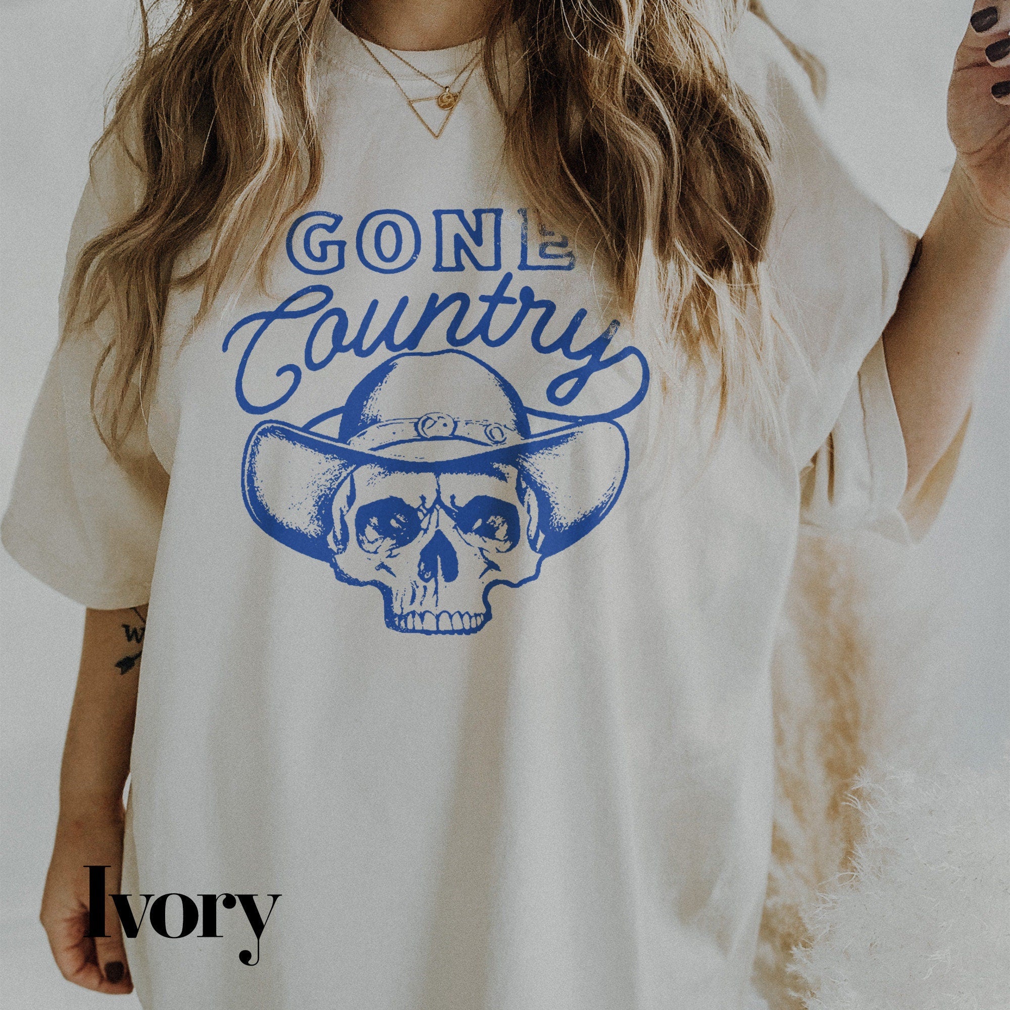 a woman wearing a white shirt with a skull on it