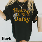 a woman wearing a black t - shirt that says have a nice daisy