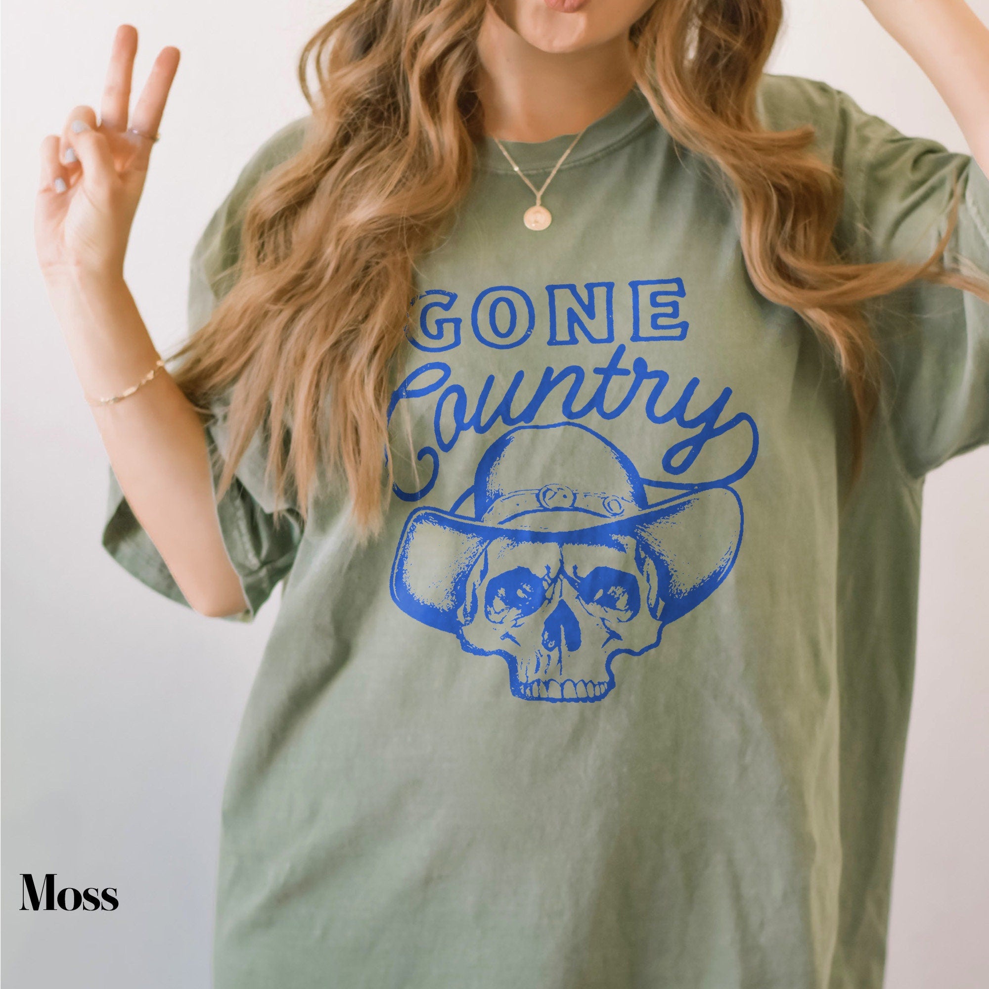 a woman with long hair wearing a green shirt
