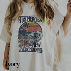 a woman wearing a t - shirt that says his mercies new every morning
