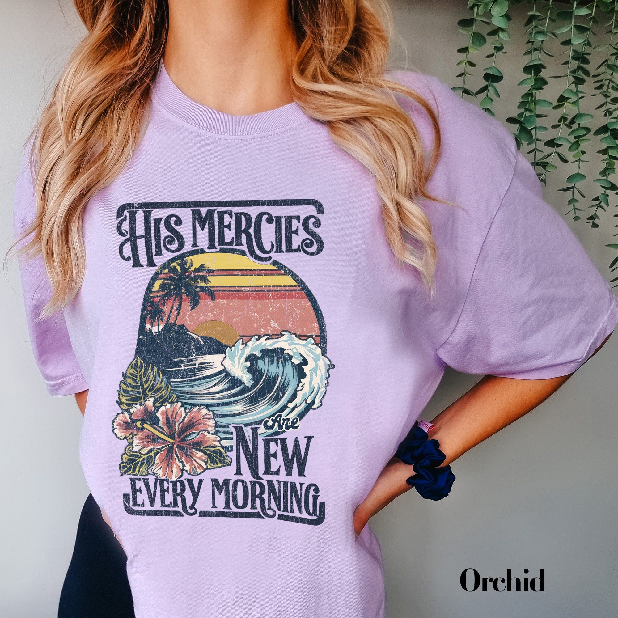 a woman wearing a purple shirt with a picture of a wave