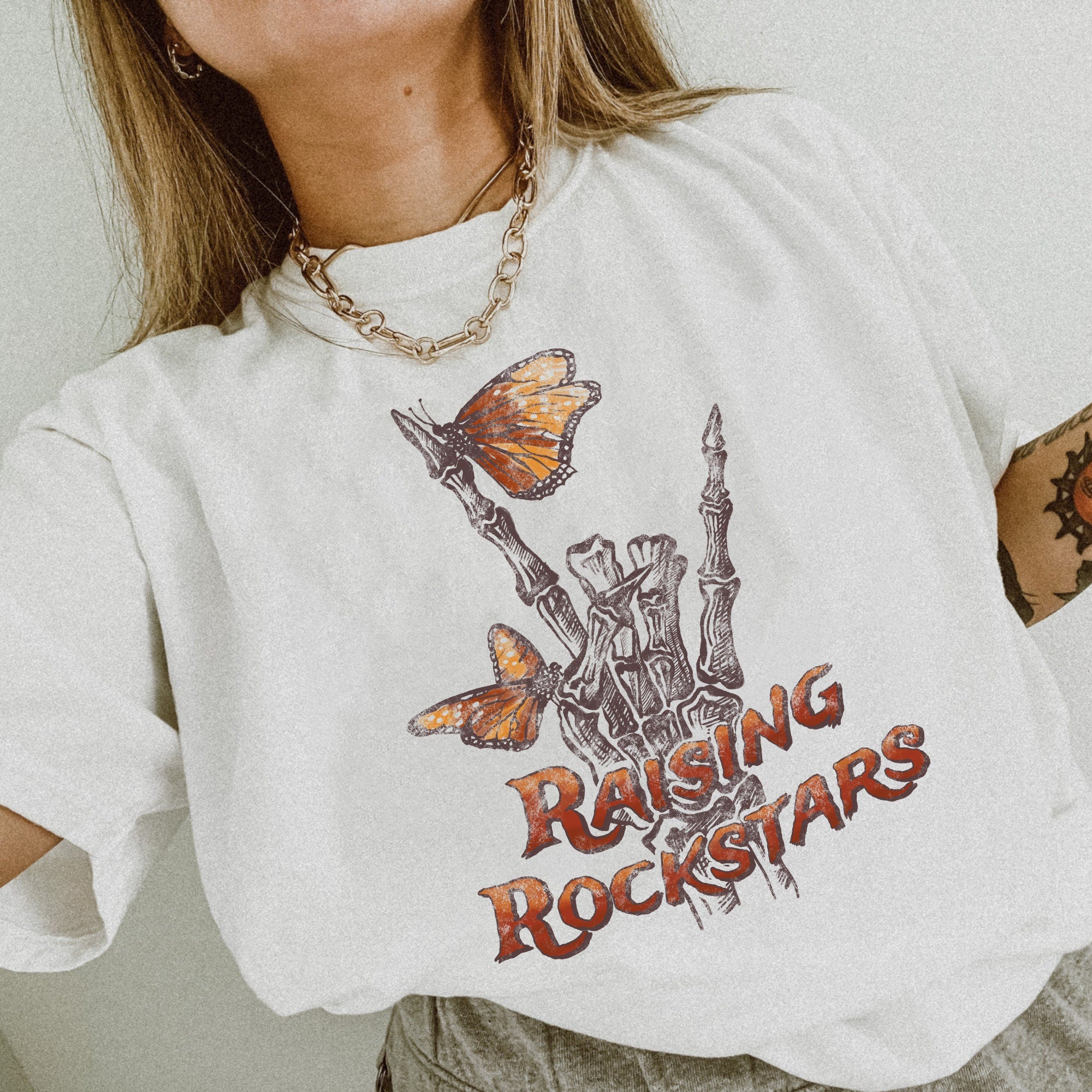 Raising Rockstars" Skeleton Hand Shirt